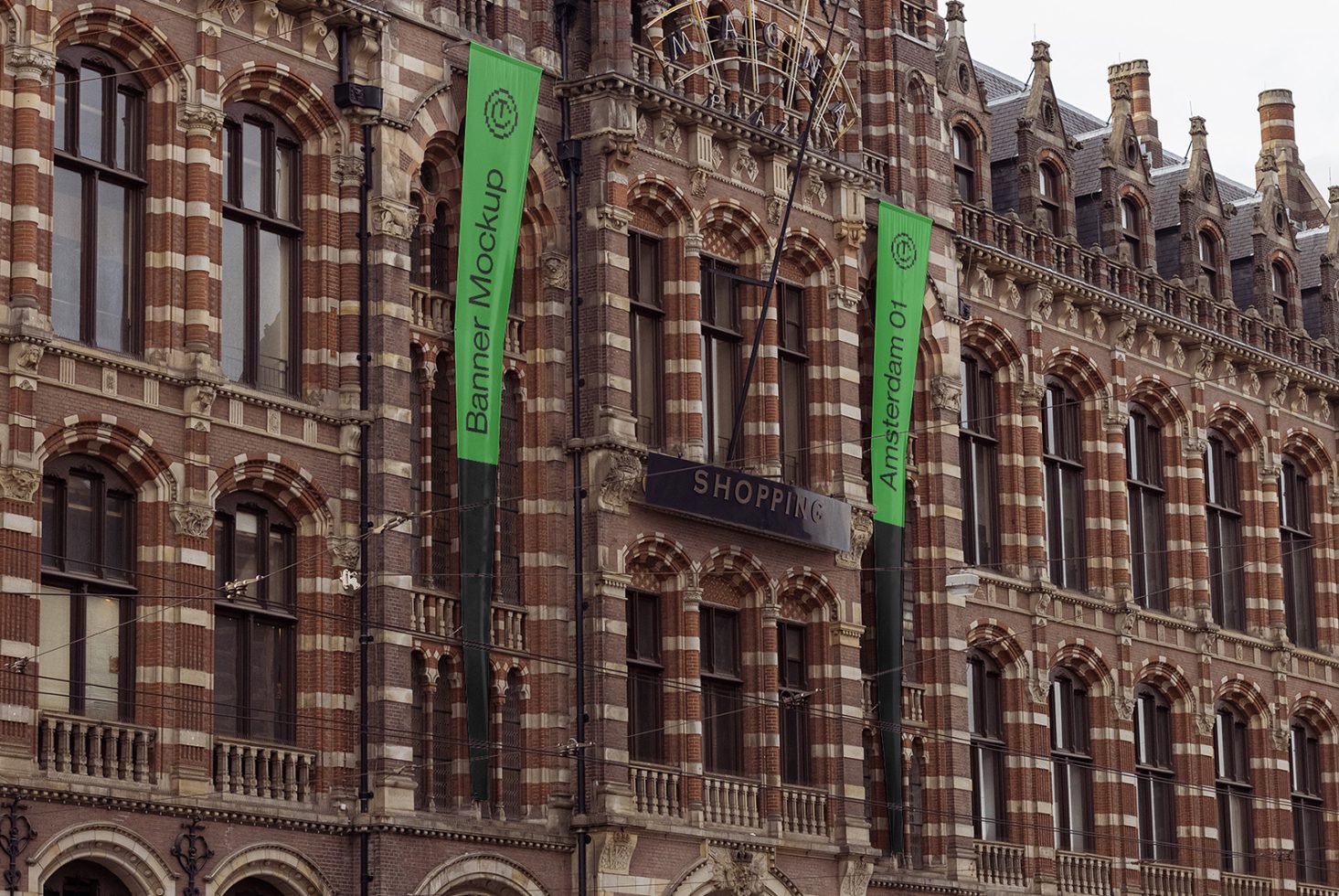 Vertical banner mockup on a historical brick building facade with shopping sign, designers marketplace, architecturally detailed structure.